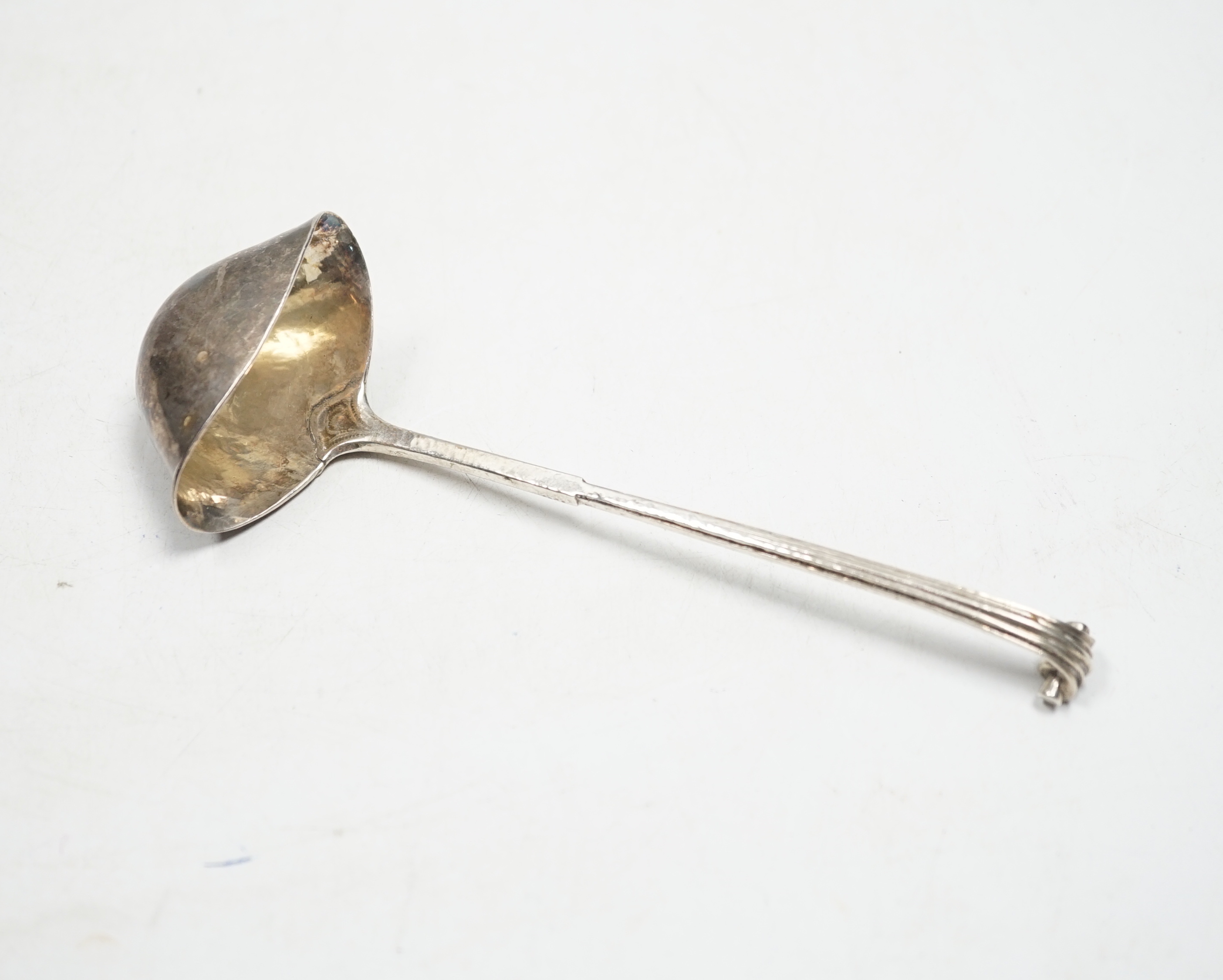A George V Arts & Craft silver cream ladle by Omar Ramsden, London, 1934, 16.7cm, 49 grams.